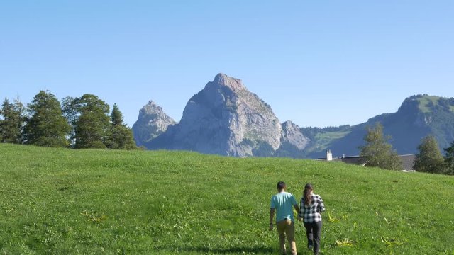 Couple walking in a meadow in switzerland