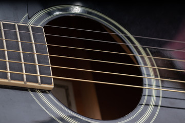 Obraz premium Close-up of black acoustic guitar