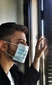 ragazzo in quarantena che guarda fuori dalla finestra durante il coronavirus
