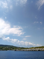 Beautiful clouds in the sky over land filled with greenery .