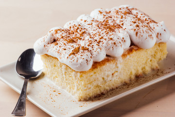 Tres leches cake, typical Latin American dessert, is made of condensed milk, evaporated milk and...