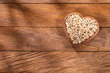 Raw Organic Pearl Barley - Hordeum vulgare. heart shaped bowl