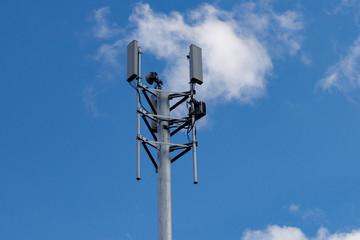Telecommunication tower with 4G, 5G transmitters. Cellular base station with transmitter antennas...