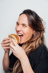 Portrait of girl eating an arepa of shredded meat. Typical Latin American food