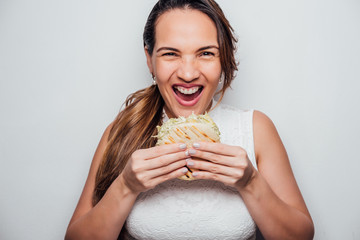 Woman with an arepa in her hands ready to eat. Latin food