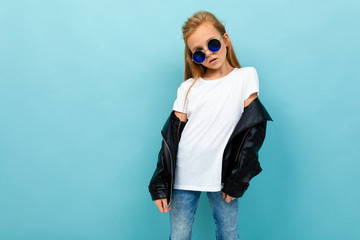 cheeky european girl in sunglasses with a tank top with mockup on a light blue background