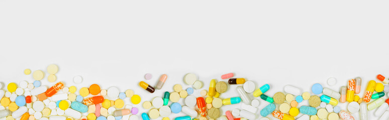 Border of assorted medicines on a white banner background with copy space