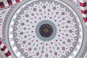 Dome of the mosque from the inside. Ceiling and chandelier in the mosque
