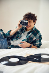 Attractive guy taking photo with vintage camera