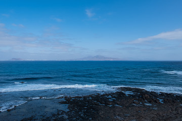 Fototapeta na wymiar Spanish View Landscape from Isla de los Lobos on Lanzarote island Tropical Volcanic Canary Islands Spain. October 2019