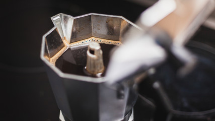 Freshly prepared, delicious hot coffee in a moka pot coffee maker. Ready to drink.