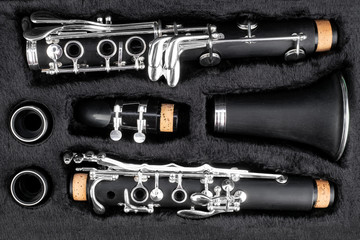 black clarinet  silver wooden woodwind musical brass instrument in pieces parts music case. classic...