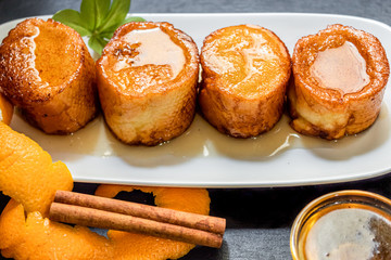 French toast in white plate on black background