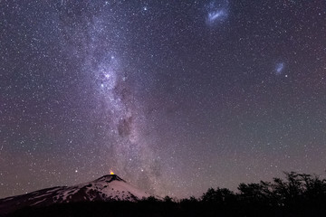 Thousands of stars in the sky with the Milky Way above the Villarrica Volcano in Chile with...