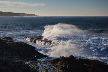Powerful waves continuously crash on the rocky coastline of northern California. This beautiful region is known for its amazing scenery and is accessible via the Pacific Coast Highway.