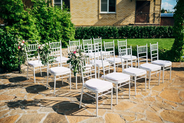 straight rows of white chairs for the wedding ceremony