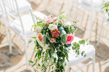 Close-up of wedding flower arrangement on a chair for guests