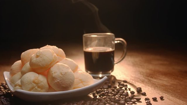 Brazilian cheese bread. Breakfast table with cheese bread, coffee, sugar and cake