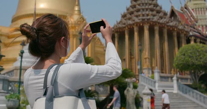 Tourist take photo on cellphone at grand palace