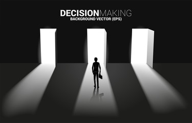 Obraz premium time to make decision in business direction. Silhouette of businessman standing to select door to enter