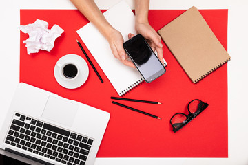 office workplace from above on a red table