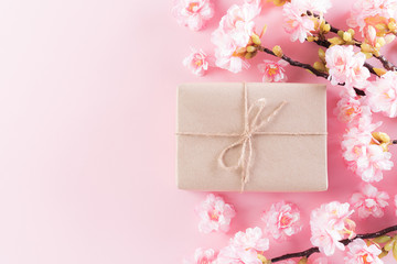 Happy Mother's Day, Women's Day or Valentine's Day greeting concept. Pastel Pink Colours Background with  blossom flowers and gift box, flat lay patterns.