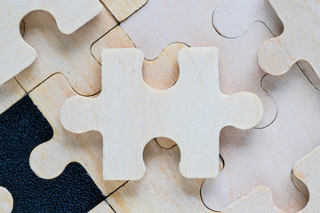 wooden jigsaw puzzle pieces on black background