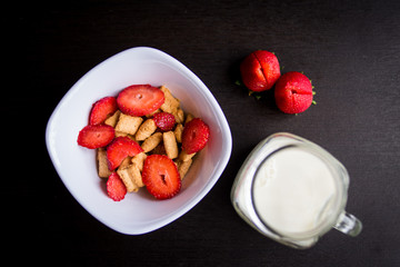Cereals with strawberries and milk as breakfast