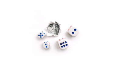 Franklin portrait in a torn hole of white paper and dice. The concept of gambling, casino, losing and luck. Win or lose. Copy space.