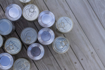A neatly organised selection of un-labelled tinned foods. 