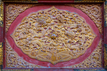 
Dragons engraved on a wood door panel at Qianqinggong (Palace of Heavenly Purity) in the Forbidden City, Beijing, China