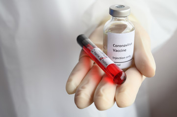 Close up of doctor hand holding a sample test of Covid-19 vaccine with blood test tube. Vaccination is one of the most effective ways to prevent diseases and helps the body&rsquo;s immune system from virus.