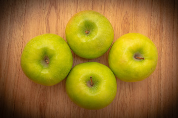 4 green apples on the table. fresh fruit.