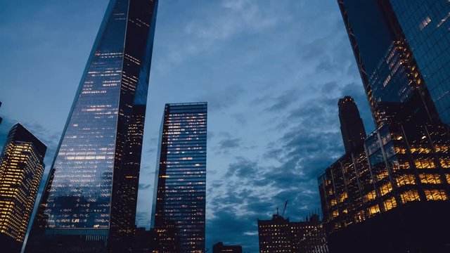 Concept of transisdence of time in metropolitan lifestyle below view of commercial buildings in perspective district, time lapse effect of general residential infrastructure in megapolis
