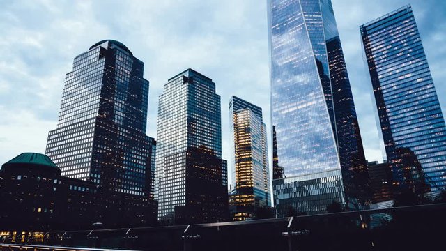 Financial district with modern headquarters and commercial construction in metropolitan downtown of big city, time lapse effect of contemporary buildings from day to night
