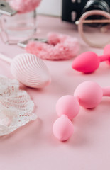 Female pink background with different sex toys. Online store, shopping, delivery, Stay at home concept