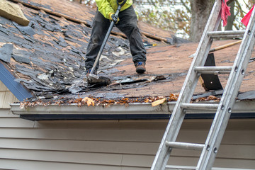 Removing roof shingles on a home