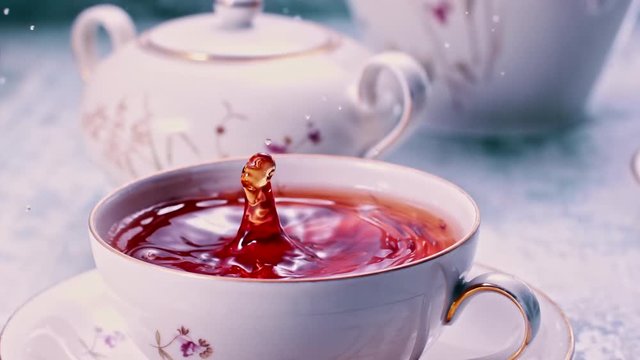 Tea drop falling in full cup of tea Super slow motion 1000fps