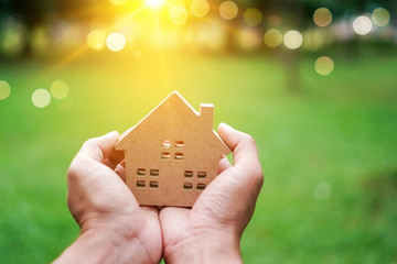 Copyspace model of a little house that woman holds it background.