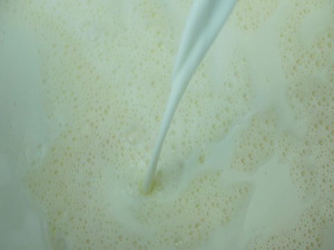Pouring fresh milk, moving water in a pot to use food , Closeup Front view Food concept.