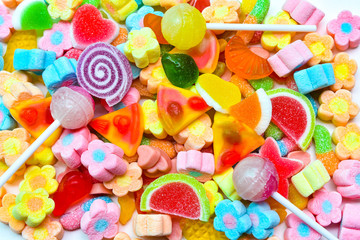 Many colorful lollipops with a sweet flavor placed on the plate.