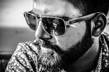 Monochromatic Close Portrait of Male model With sunglasses and beard