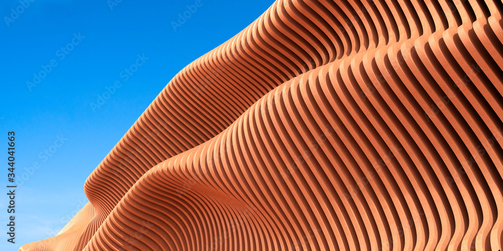 Leinwandbilder abstract building with wooden facade pattern on blue sky background, flowing shape, architecture wit