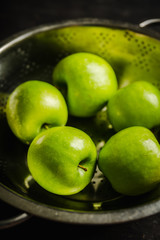 Close-up green apples on the rustic wooden background. Selective focus. Shallow depth of field.
