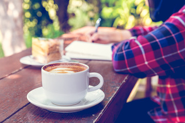 Close up cup of hot coffee on wooden table