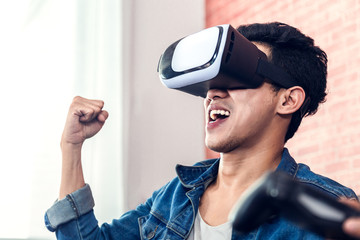 Man wearing virtual reality glasses enjoying game or 3D movies