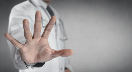 Medicine doctor or pharmacist show a stop hand.