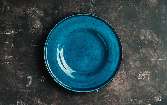 Clean Blue Plate On The Rustic Background. Selective Focus. Shot From Above.