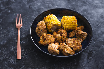 plant-based food, vegan buffalo cauliflower florets and grilled corn cobs