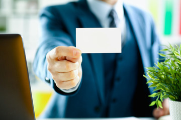 Male arm in suit give blank calling card to visitor closeup. White collar colleagues company name exchange job interview sale clerk id executive or ceo finance support formal identity concept